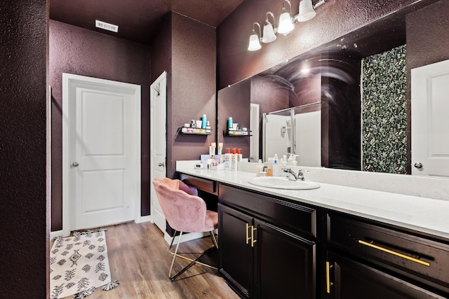 1823 Wolf Run, Anna, TX 75409 - bathroom with vanity, a textured wall, wood finished floors, and visible vents