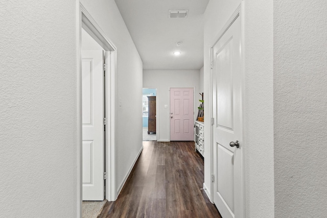 1823 Wolf Run, Anna, TX 75409 - hallway with baseboards, a textured wall, dark wood finished floors, and visible vents