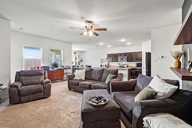 1823 Wolf Run, Anna, TX 75409 - living room featuring a ceiling fan, a textured ceiling, and light colored carpet