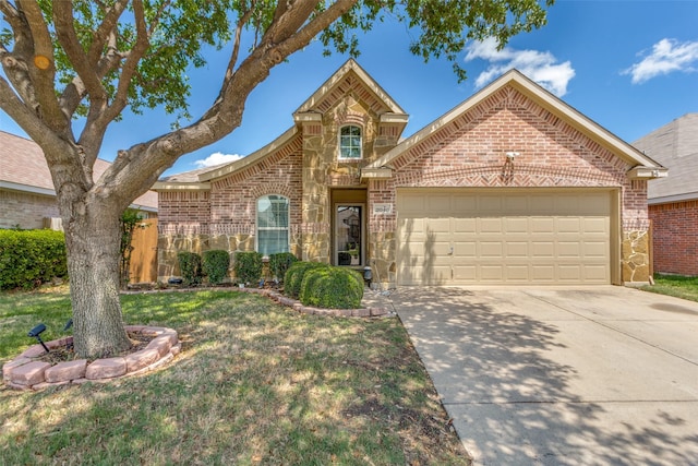 view of front of house featuring an attached garage, concrete driveway, stone siding, and brick siding