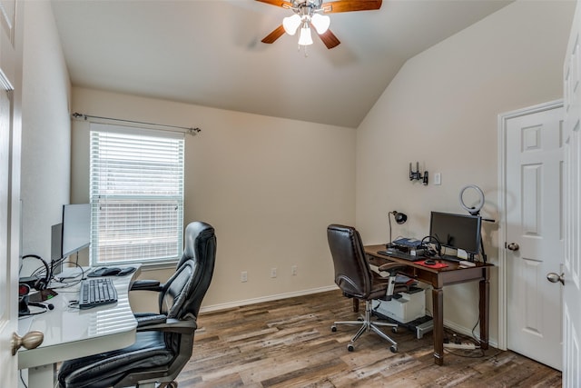 office area featuring wood finished floors, baseboards, ceiling fan, and lofted ceiling