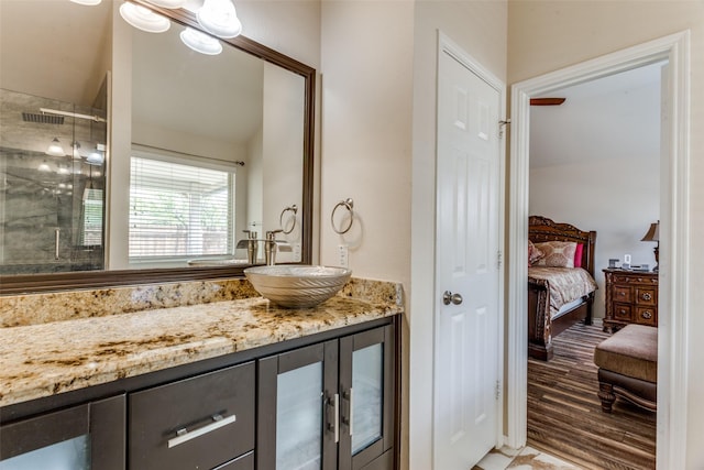ensuite bathroom with vanity, a stall shower, connected bathroom, and visible vents