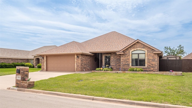 ranch-style house featuring fence, a front lawn, brick siding, a garage, and driveway