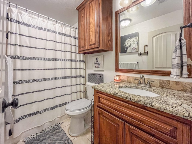 bathroom with tile patterned flooring, a shower with shower curtain, toilet, and vanity