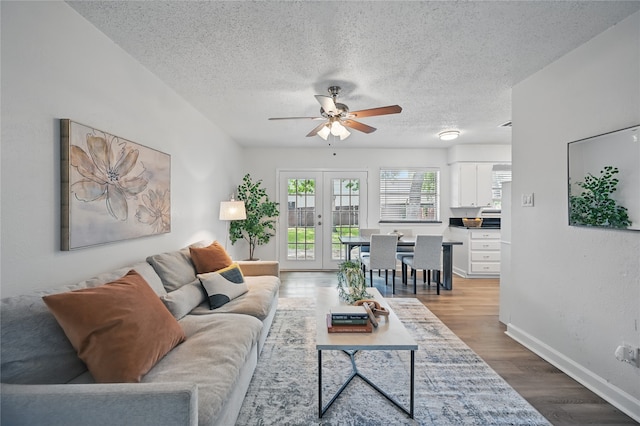 528 Chambers St, Denton, TX 76205 - living room with a textured ceiling, french doors, a ceiling fan, baseboards, and wood finished floors