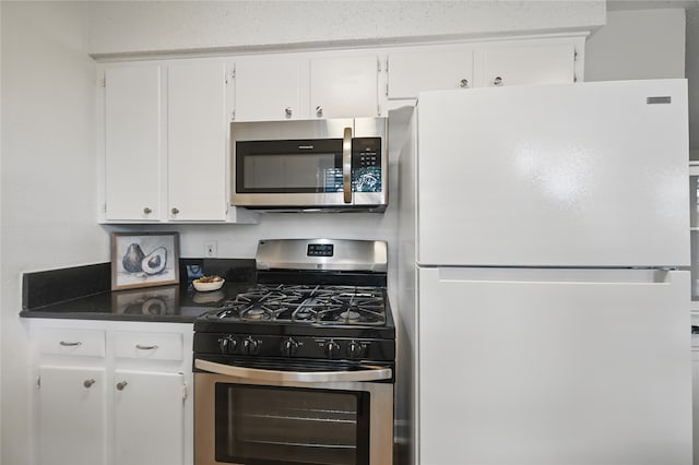 528 Chambers St, Denton, TX 76205 - kitchen with white cabinetry, dark countertops, and stainless steel appliances