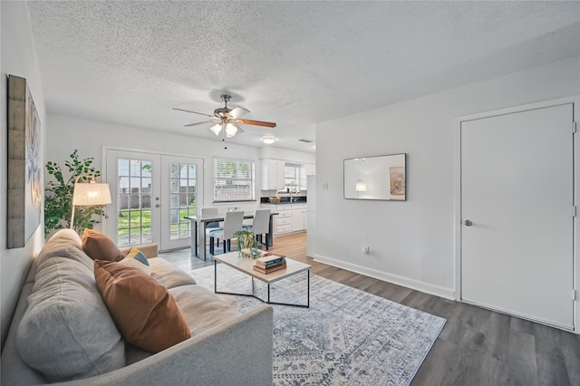 528 Chambers St, Denton, TX 76205 - living area with wood finished floors, baseboards, a textured ceiling, french doors, and a ceiling fan