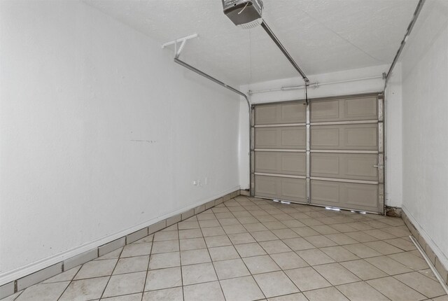 528 Chambers St, Denton, TX 76205 - garage featuring baseboards and a garage door opener