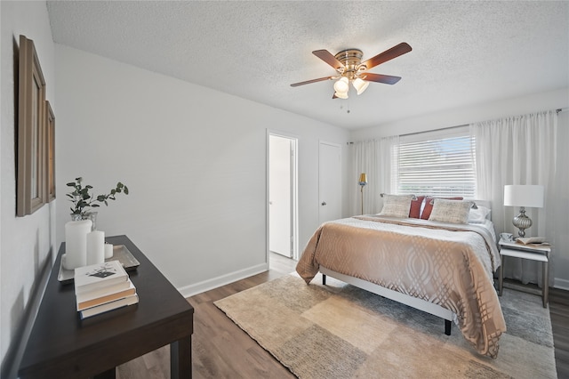 528 Chambers St, Denton, TX 76205 - bedroom featuring baseboards, ceiling fan, a textured ceiling, and wood finished floors