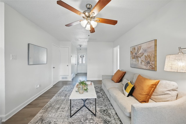 528 Chambers St, Denton, TX 76205 - living room with ceiling fan, visible vents, dark wood-style floors, and baseboards