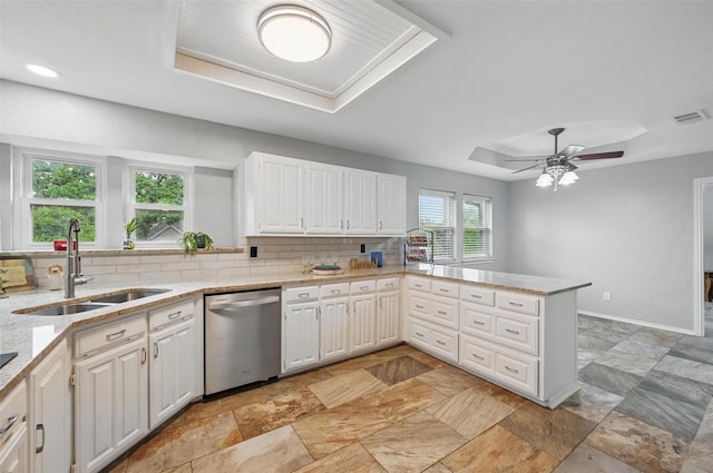 818 Red Oak Dr, Mansfield, TX 76063 - kitchen featuring stainless steel dishwasher, a raised ceiling, a sink, decorative backsplash, and a peninsula