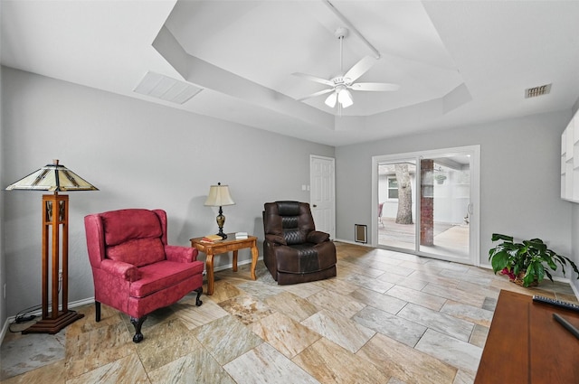 818 Red Oak Dr, Mansfield, TX 76063 - living area featuring a raised ceiling, ceiling fan, baseboards, and light stone finish flooring