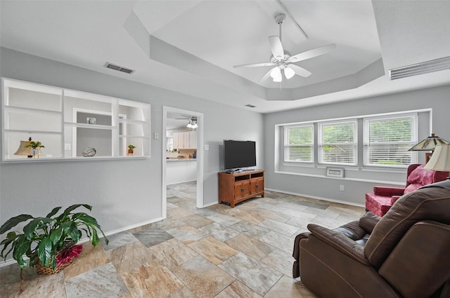 818 Red Oak Dr, Mansfield, TX 76063 - living area with ceiling fan, baseboards, a raised ceiling, and stone finish floors