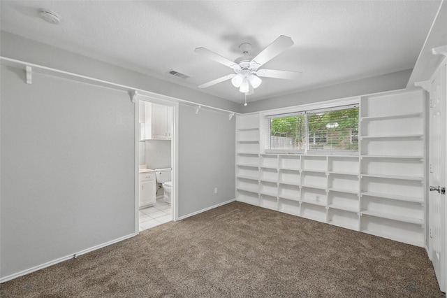 818 Red Oak Dr, Mansfield, TX 76063 - unfurnished bedroom featuring carpet, ensuite bathroom, a ceiling fan, and a textured ceiling
