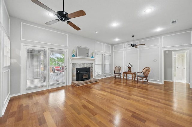 818 Red Oak Dr, Mansfield, TX 76063 - living area with a ceiling fan, a decorative wall, a wood stove, wood finished floors, and recessed lighting