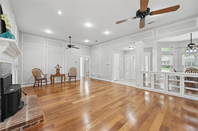 818 Red Oak Dr, Mansfield, TX 76063 - living room with a ceiling fan, a decorative wall, light wood-style floors, and recessed lighting