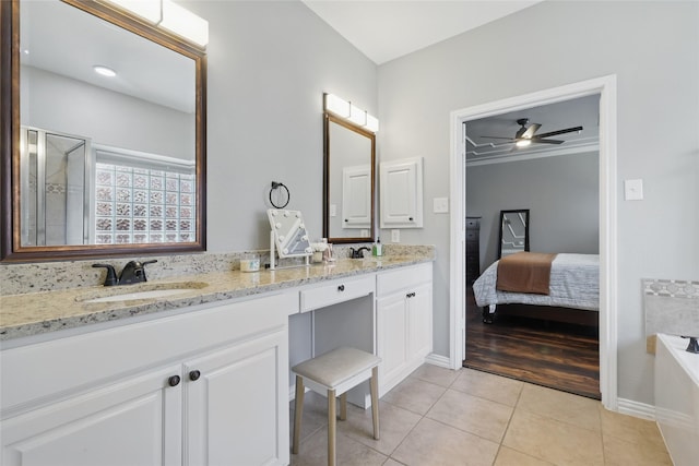 8208 Rock Elm Rd, Fort Worth, TX 76131 - bathroom featuring tile patterned flooring, ceiling fan, double vanity, a garden tub, and baseboards