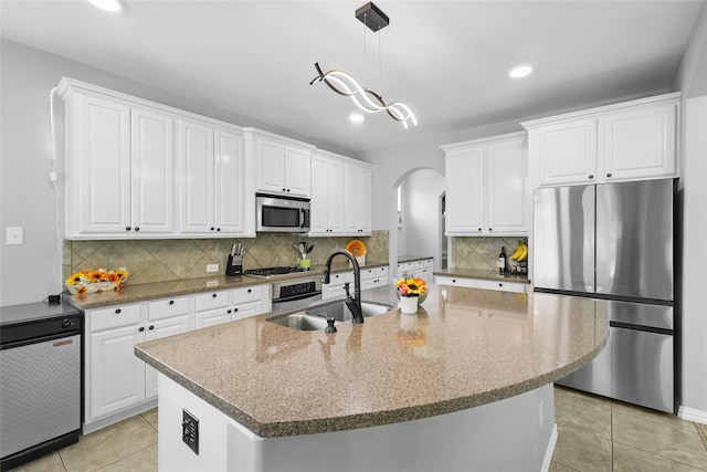 8208 Rock Elm Rd, Fort Worth, TX 76131 - kitchen featuring stainless steel appliances, arched walkways, a sink, white cabinetry, and recessed lighting