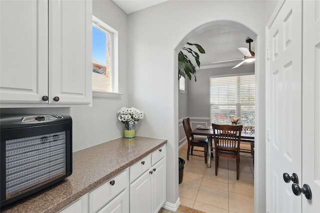 8208 Rock Elm Rd, Fort Worth, TX 76131 - kitchen with ceiling fan, white cabinets, arched walkways, and healthy amount of natural light