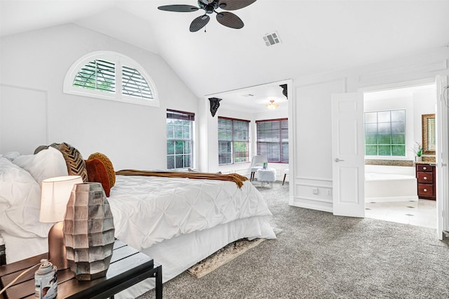 bedroom featuring visible vents, ceiling fan, high vaulted ceiling, carpet flooring, and ensuite bath