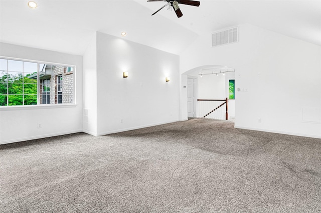 unfurnished living room featuring visible vents, a ceiling fan, carpet floors, and lofted ceiling