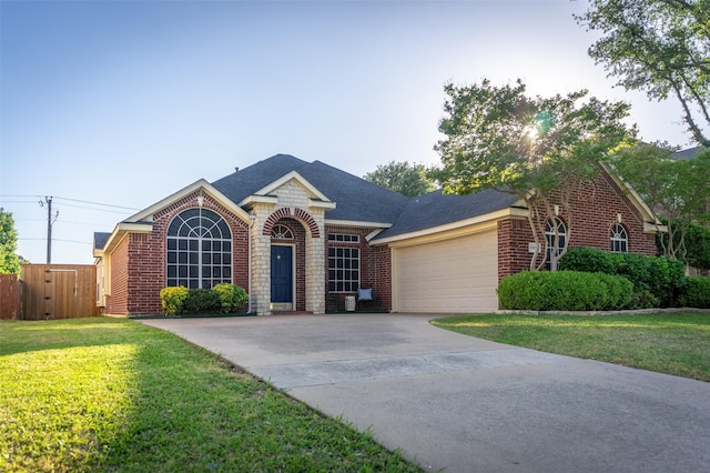ranch-style home with fence, an attached garage, a front lawn, brick siding, and driveway
