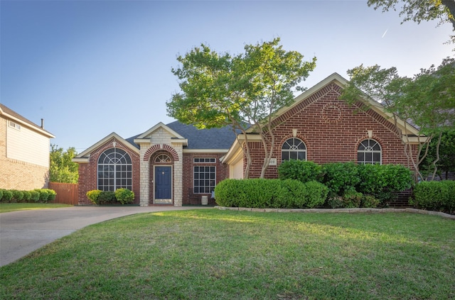 ranch-style house with brick siding and a front lawn