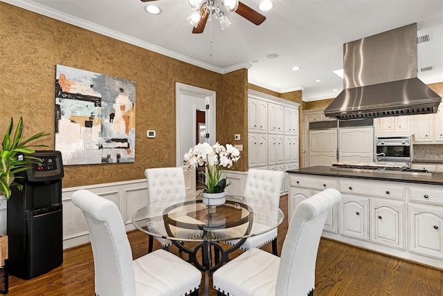 dining space with ceiling fan, dark wood-style flooring, wainscoting, ornamental molding, and recessed lighting