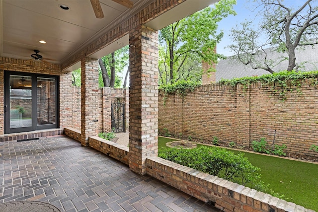 view of patio featuring a fenced backyard, ceiling fan, and french doors
