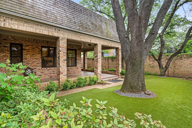 view of yard featuring a porch and fence
