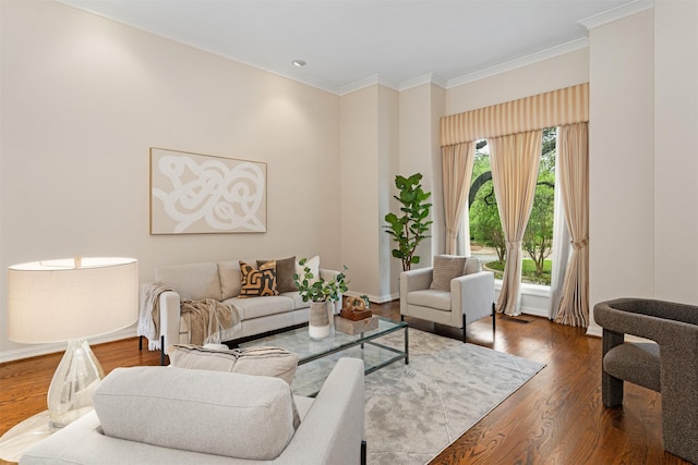 living room with crown molding, baseboards, and wood finished floors