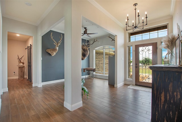 foyer entrance featuring baseboards, ornamental molding, and a healthy amount of sunlight