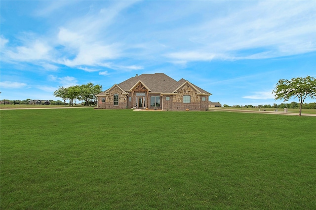 view of front of house with a front lawn and stone siding