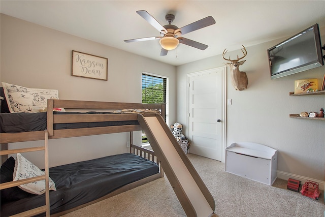 bedroom featuring baseboards, a ceiling fan, and carpet