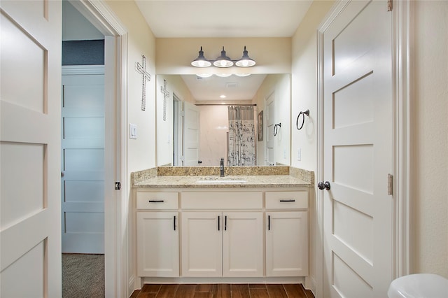 bathroom featuring a shower with curtain, wood finished floors, and vanity