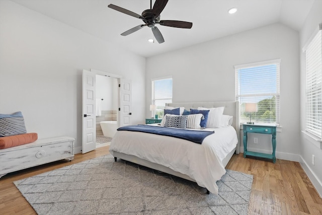 bedroom featuring light wood-style floors, multiple windows, recessed lighting, and connected bathroom