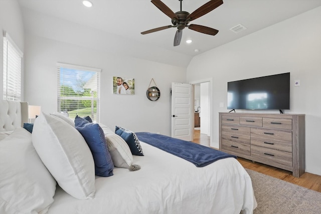 bedroom featuring ceiling fan, visible vents, vaulted ceiling, light wood-type flooring, and recessed lighting