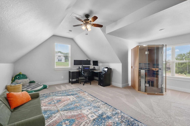 home office with a ceiling fan, baseboards, vaulted ceiling, and carpet