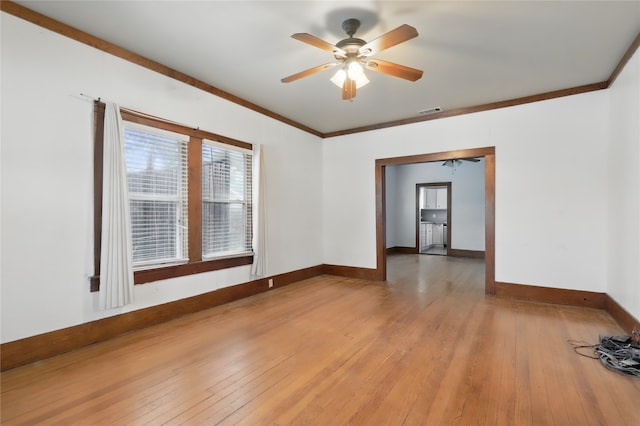 unfurnished room featuring a ceiling fan, baseboards, light wood-type flooring, visible vents, and ornamental molding