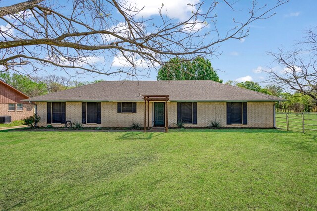 ranch-style house with brick siding, central AC, fence, and a front lawn