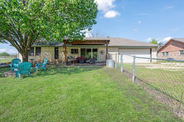 rear view of house with brick siding, a garage, a fenced backyard, a lawn, and driveway