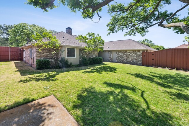 view of yard with fence and a gate