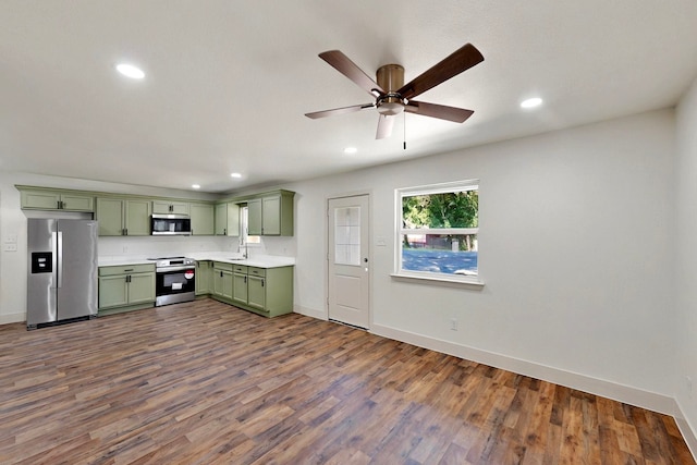 2188 Jordan Valley Dr, Dallas, TX 75253 - kitchen with green cabinets, stainless steel appliances, baseboards, dark wood-style flooring, and ceiling fan