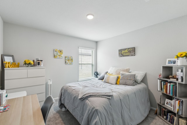 bedroom featuring baseboards and carpet