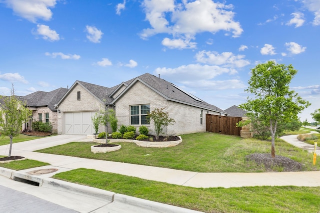 view of front of property featuring driveway, brick siding, fence, a front lawn, and an attached garage