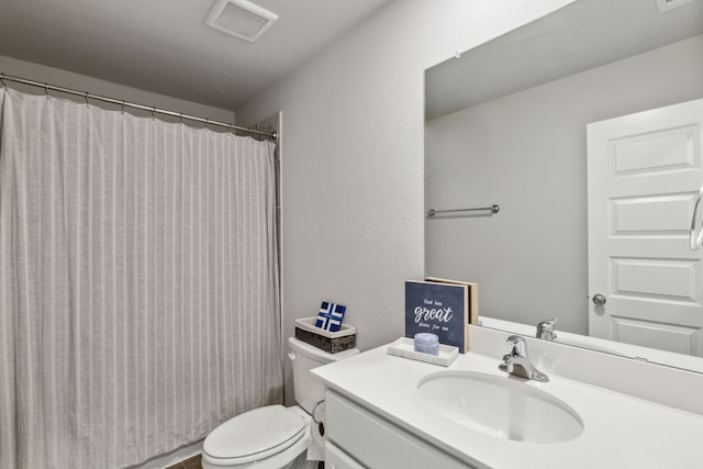 bathroom with visible vents, curtained shower, toilet, and vanity