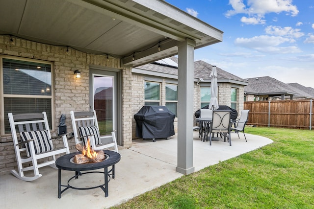 view of patio featuring an outdoor fire pit, fence, and a grill