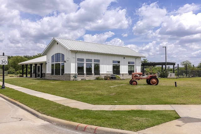 1424 Bellaire St, Celina, TX 75009 - view of front of property featuring board and batten siding, a front lawn, a metal roof, and a standing seam roof