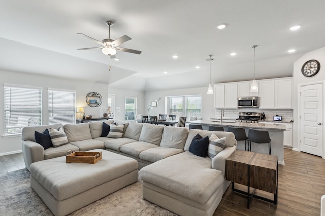 living area with baseboards, recessed lighting, ceiling fan, and wood finished floors