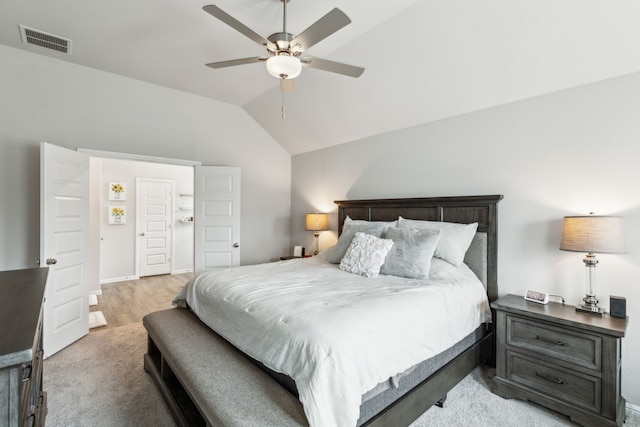 bedroom with a ceiling fan, visible vents, light carpet, and vaulted ceiling